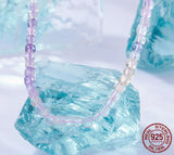 Necklace with purple and clear beads on a light blue crystal background, featuring the Bamoer brand.