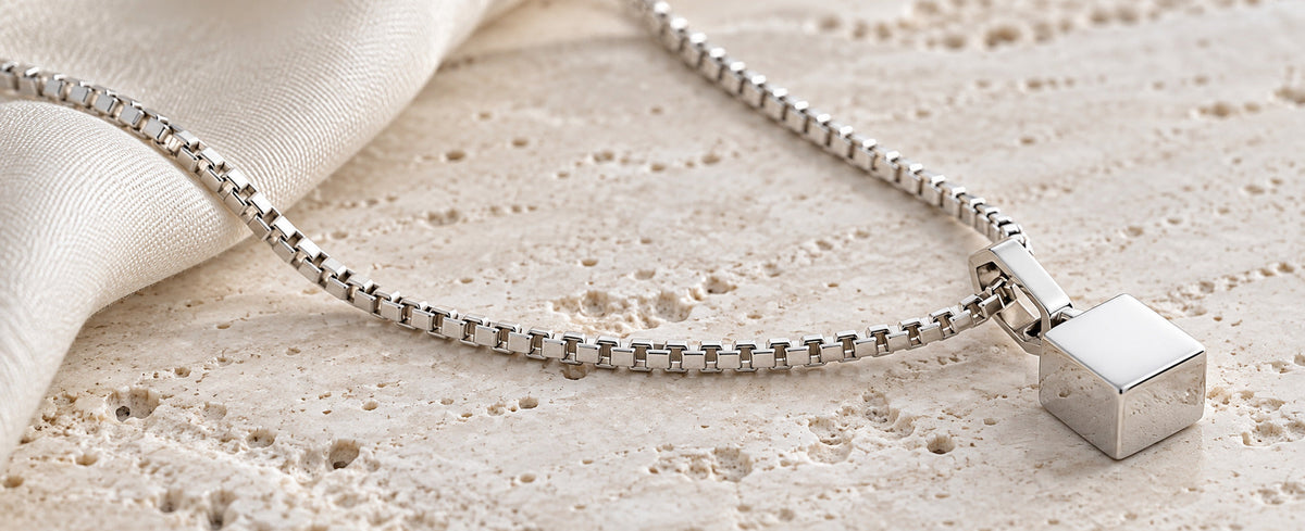 Sterling silver box chain with geometric pendant showing square links for Jewelry Towns guide