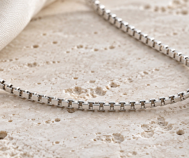 Sterling silver box chain with geometric pendant showing square links for Jewelry Towns guide