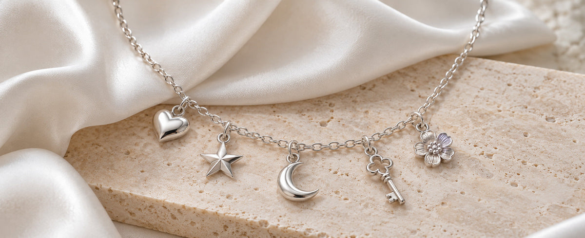 Sterling silver charm necklace with heart star moon key and flower charms for Jewelry Towns guide
