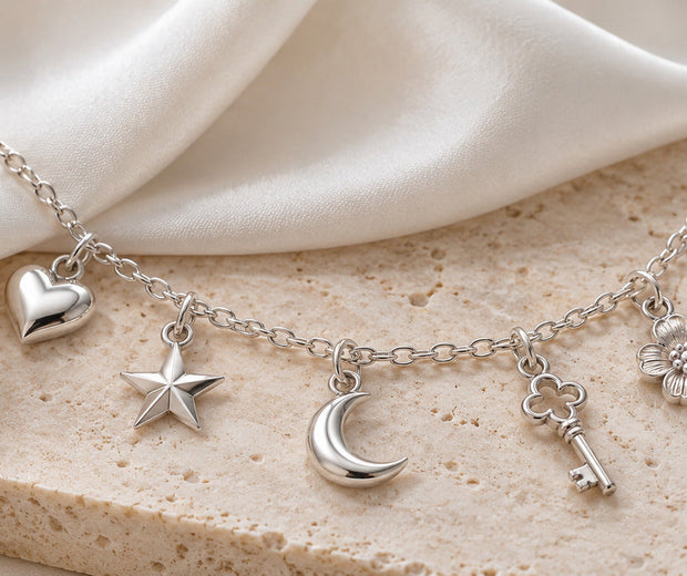 Sterling silver charm necklace with heart star moon key and flower charms for Jewelry Towns guide