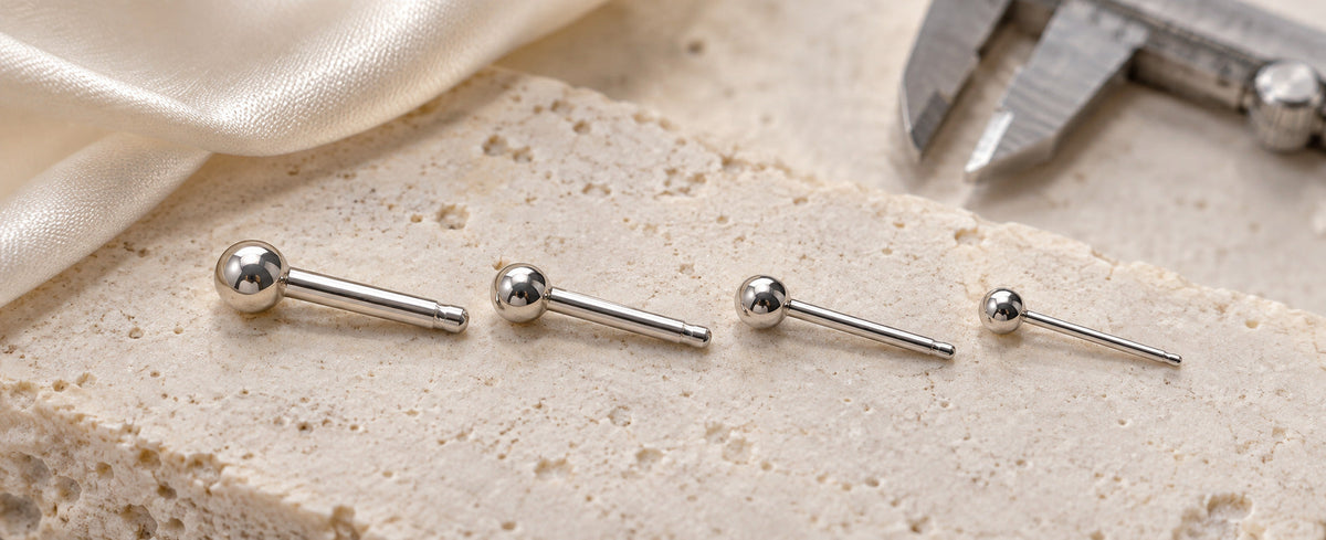 Four sterling silver earring posts arranged from thickest to thinnest for Jewelry Towns gauge guide