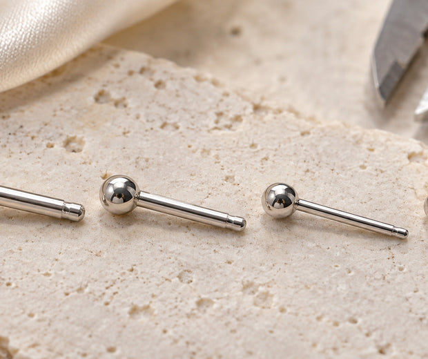 Four sterling silver earring posts arranged from thickest to thinnest for Jewelry Towns gauge guide