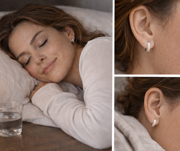 Woman peacefully sleeping on a pillow while wearing silver huggie earrings, shown in a warm editorial collage with a close-up of the earring and a realistic bedtime lifestyle detail.