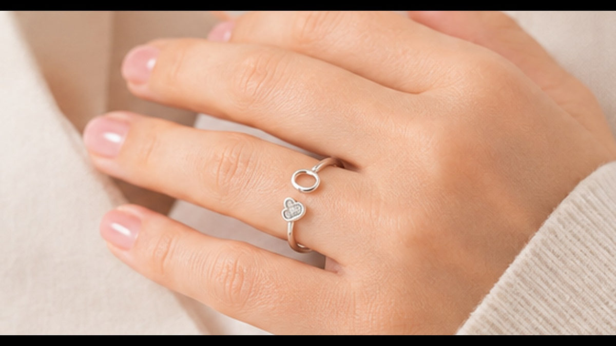 Woman wearing a delicate silver adjustable open ring with a heart detail — Jewelry Towns adjustable rings guide