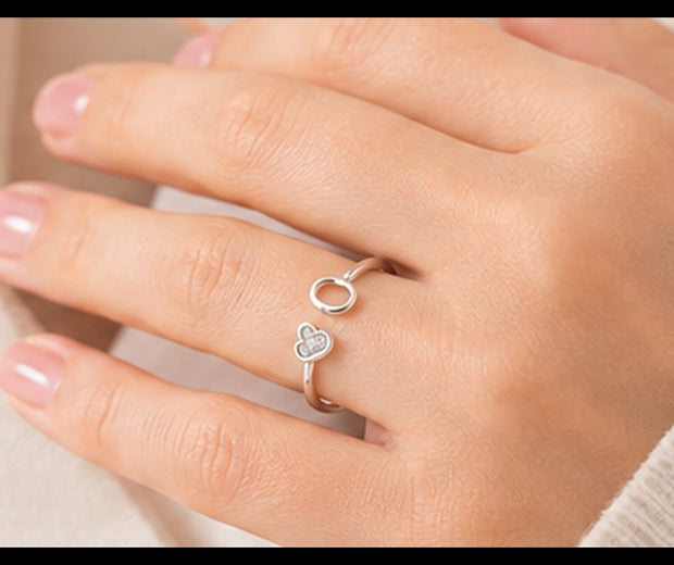 Woman wearing a delicate silver adjustable open ring with a heart detail — Jewelry Towns adjustable rings guide