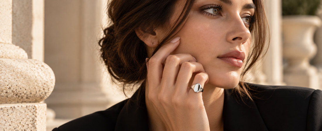 Woman wearing a polished silver pinky ring in a modern 2026 jewelry editorial