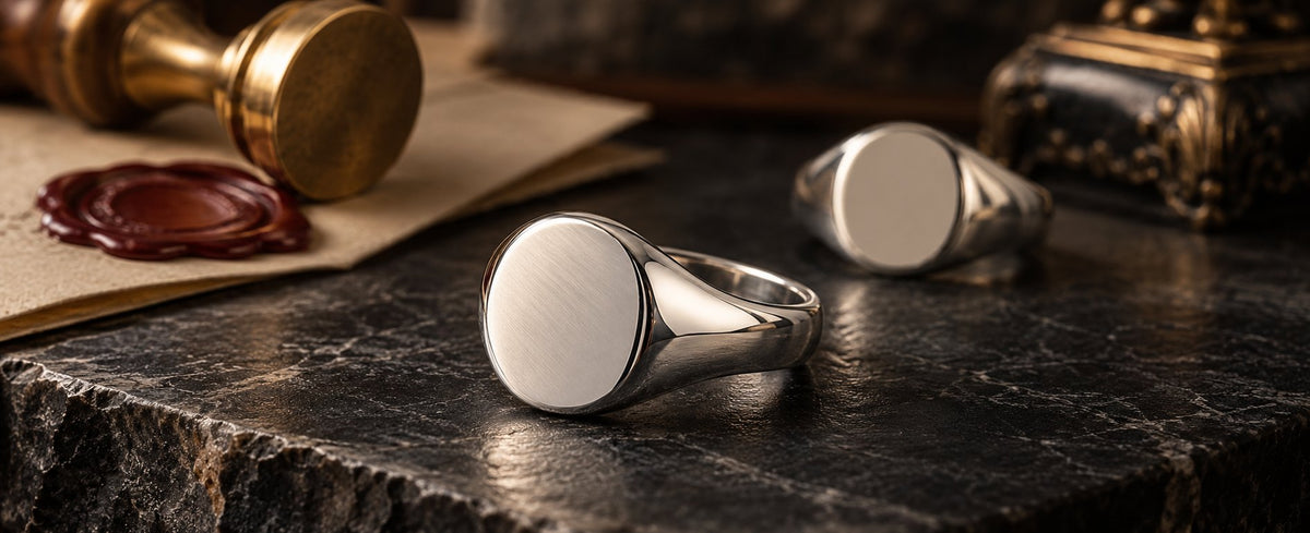 Polished signet rings beside a wax seal for Jewelry Towns signet ring guide