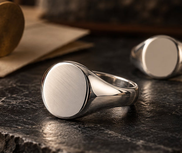 Polished signet rings beside a wax seal for Jewelry Towns signet ring guide