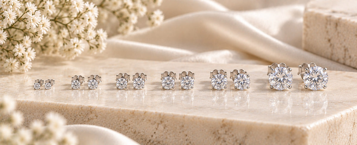 Seven pairs of round 925 sterling silver stud earrings arranged from tiny to bold sizes for Jewelry Towns stud earring size guide