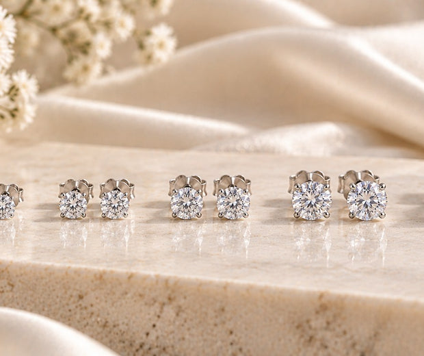 Seven pairs of round 925 sterling silver stud earrings arranged from tiny to bold sizes for Jewelry Towns stud earring size guide