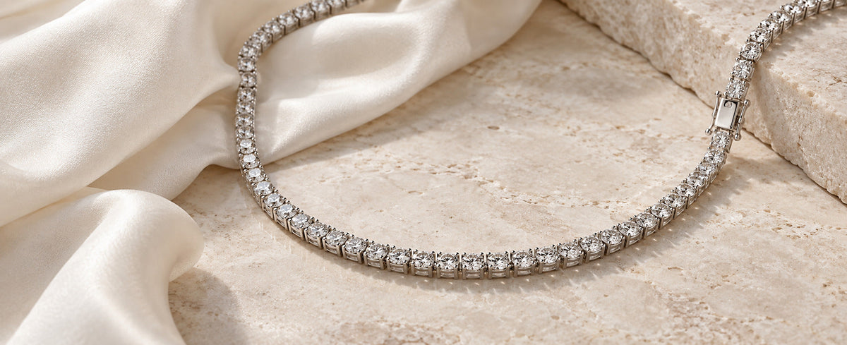 Continuous stone tennis necklace on ivory satin for Jewelry Towns tennis necklace guide