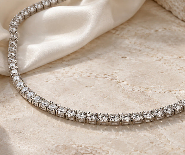 Continuous stone tennis necklace on ivory satin for Jewelry Towns tennis necklace guide