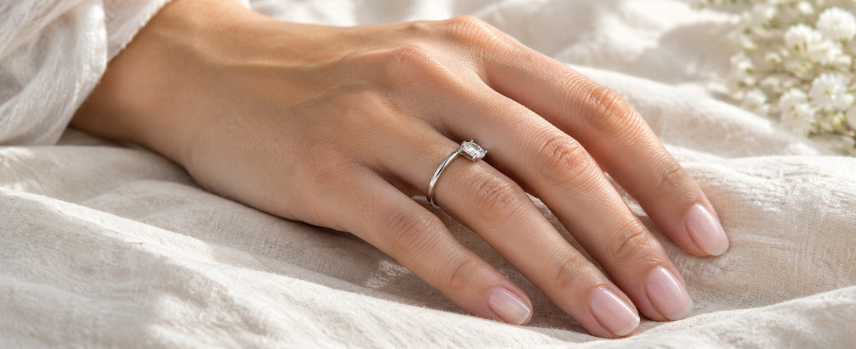Sterling silver solitaire ring rotated sideways on the finger for Jewelry Towns ring fit guide