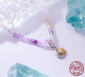 Necklace with a sun-shaped pendant and beaded chain on a light background with 'bamoer' branding.